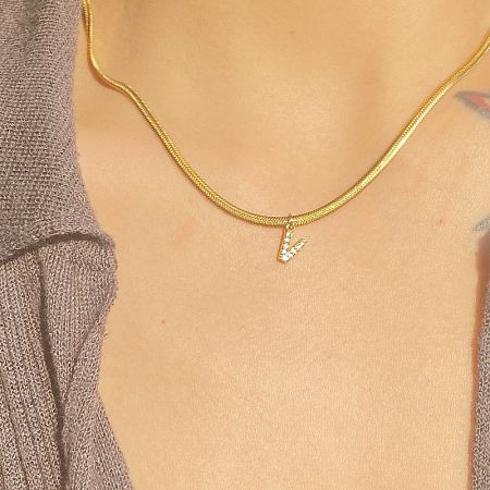 A close-up of the 'V' initial pendant necklace, emphasizing its brilliant shine and quality craftsmanship.
