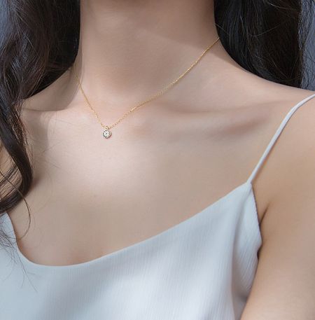 Detailed view of the Evil Eye pendant on the gold necklace, showcasing the intricate setting of the cubic zirconia.