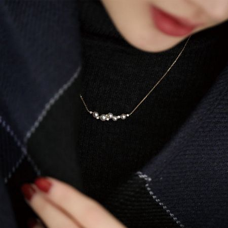 Model wearing the 925 sterling silver shell pearl necklace, showcasing its collarbone length.