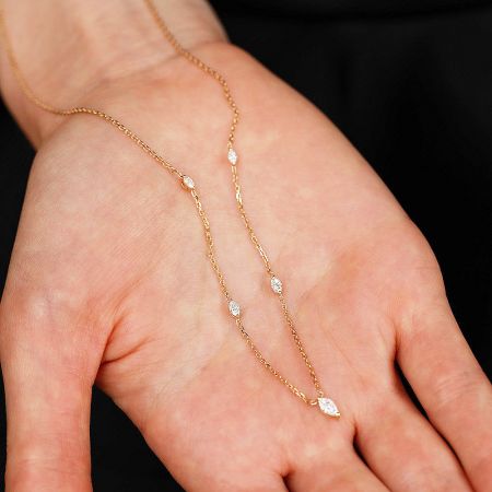 Close-up of the marquise-cut zircon stone charm on the gold-finished sterling silver necklace.