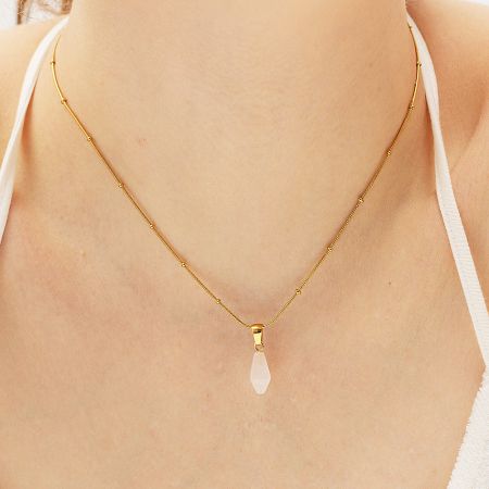 Rose Quartz pendant on a gold necklace, showcasing its delicate pink hue.