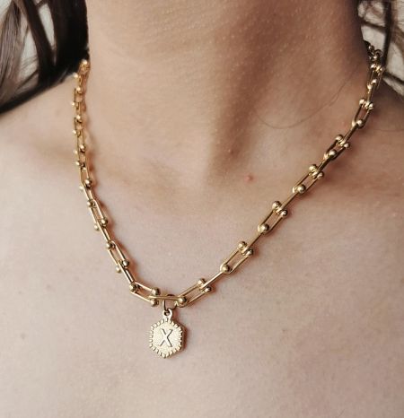 Example of the personalized necklace with a gold 'X' initial pendant.