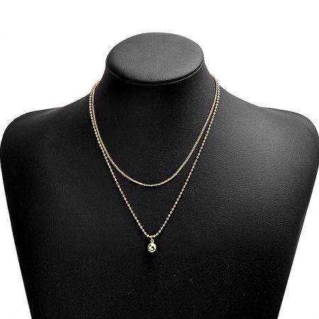 The Double Chain Layered Mini Ball Necklace displayed on a black bust to showcase its design.