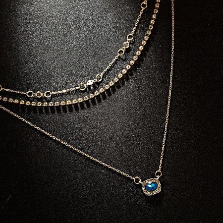 Another perspective of the three gold necklaces, showing their elegant drape.