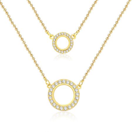 Close-up view of the two circular pendants, showcasing the sparkling cubic zirconia stones set in the gold-plated brass.