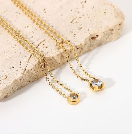 Comparison of the Delicate Round Solitaire Necklace in both gold and silver plating options.