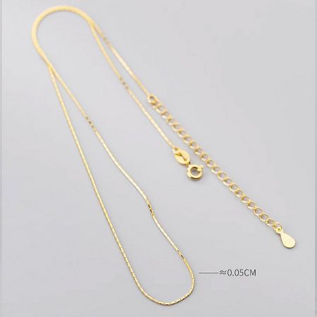 Close-up of the gold snake chain necklace, illustrating its super thin and flexible design.