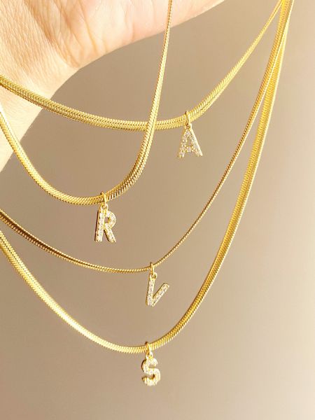A beautiful display of various gold initial necklaces from the collection.