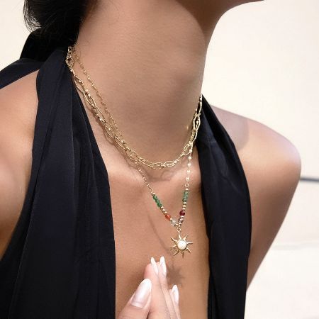 Close-up of the colorful beaded sun pendant necklace highlighting the non-tarnish stainless steel and PVD gold plating.