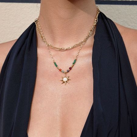 Layered look featuring the stainless steel sun charm necklace, showcasing its bohemian style for beach fashion.