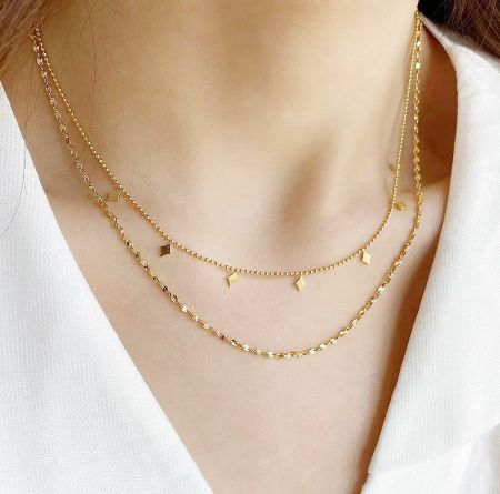 Stainless Steel Gold Double-Layered Chain Fringe Necklaces Set of 5 - A woman wearing the elegant stainless steel gold double-layered chain fringe necklaces, showcasing their stylish look.