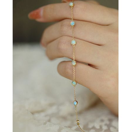Another view of the mini opal chain bracelet, highlighting its shimmering stones.