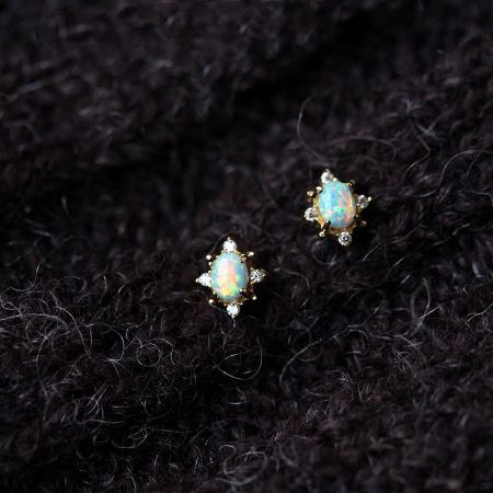 A pair of gold earrings featuring brilliant opal stones and sparkling diamond accents.