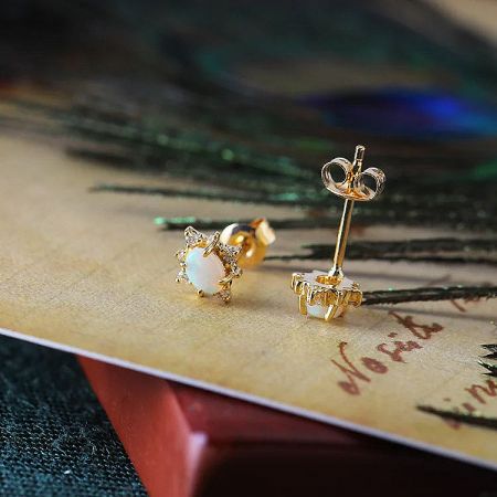 Detailed front and back view of the gold opal earrings, highlighting the craftsmanship and clasp mechanism.