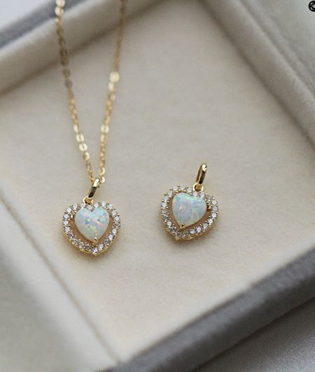 A beautiful jewelry set including the gold-plated heart opal necklace and matching earrings.
