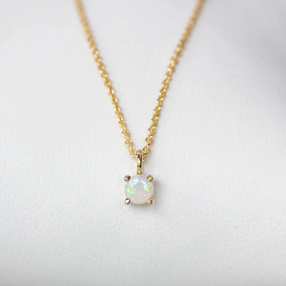 Detailed view of the lustrous opal pendant on the gold-plated sterling silver chain.