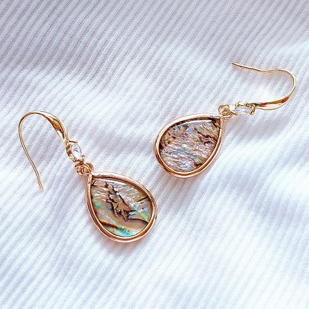 Side view of the shell teardrop fish hook earring, displaying its elegant design and gold finish.
