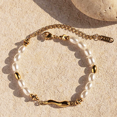 Detailed shot of the K18 gold clasp on the stainless steel pearl bracelet.