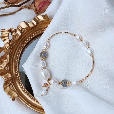 Detailed view of the gold plated bracelet highlighting the lustrous freshwater pearls and grey moonstone beads.