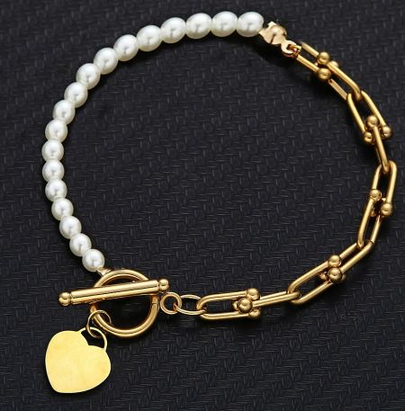 Gold-plated version of the Hearty Pearl Toggle Bracelet, showcasing the heart charm and pearl details.