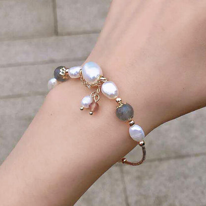 14k Gold Plated Freshwater Pearl with Grey Moonstone Bracelets Set of 5 - A close-up of a woman's wrist wearing an elegant 14k gold plated bracelet set featuring freshwater pearls and grey moonstone beads.
