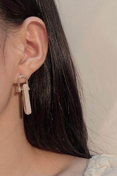 Model wearing the Pearl Chain Link Drop Earrings to showcase their length and style.