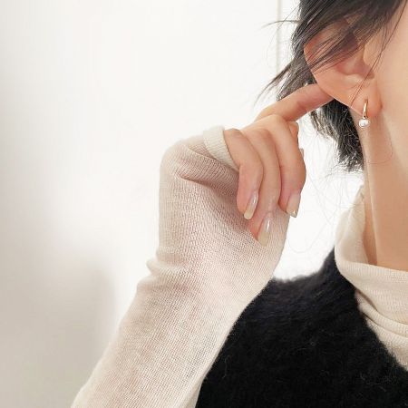 Close-up shot highlighting the lustrous freshwater pearl and the quality of the 925 sterling silver hook.