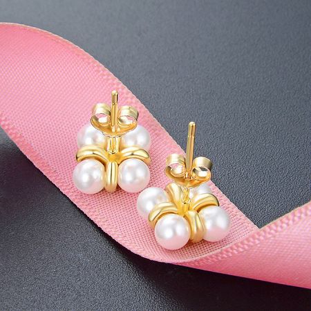 Detailed view of the pearl arrangement on the sterling silver stud earrings.