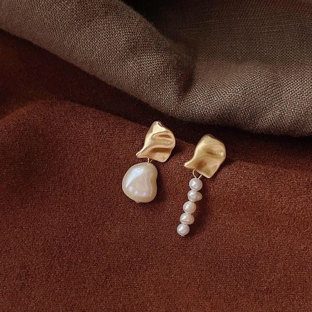 Another unique design from the set of five asymmetrical gold and pearl earrings.
