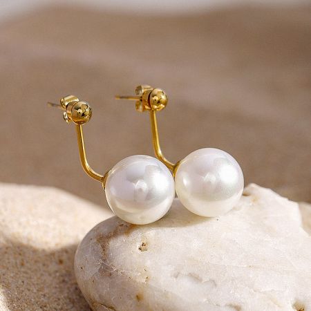 A pair of lustrous pearl earrings with gold findings.