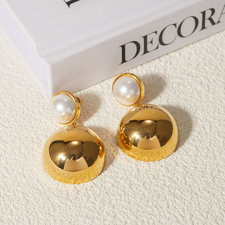 A clear product image of the gold and pearl earrings, emphasizing their luxurious design.