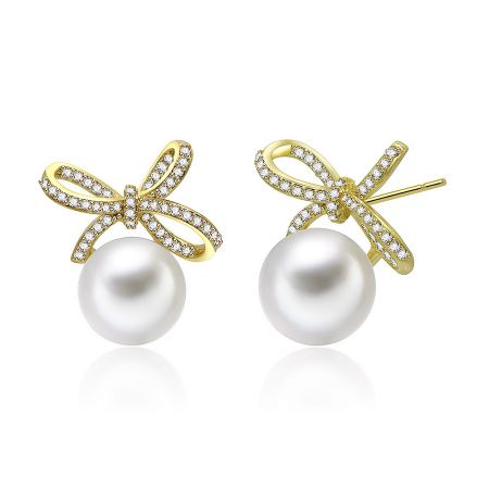 Close-up view of the Pearly Gold Bow Drops Stud Earrings, highlighting the large white pearl and gold bow.