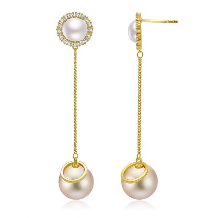 Detailed view of the gold pearl earrings with sparkling diamond accents.