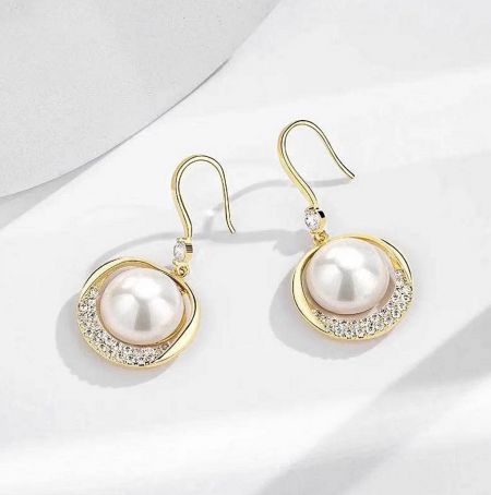 Detailed view of the pearl drop earrings showcasing the intricate crystal setting.