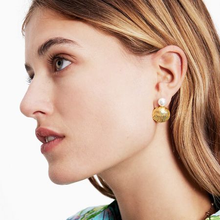 Side view of the gold pearl and shell stud earring.