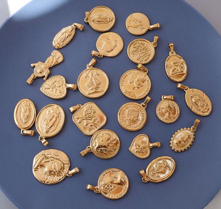 Assortment of custom gold-plated religious pendants in various shapes and styles.
