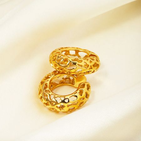 A set of gold-plated perforated ear cuffs showcasing various cutout shapes.