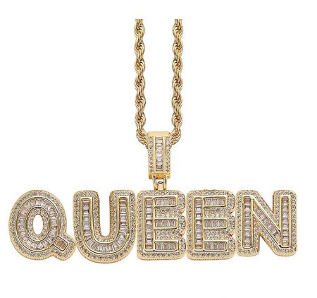 Close-up of a custom gold 'QUEEN' pendant necklace with diamond accents.