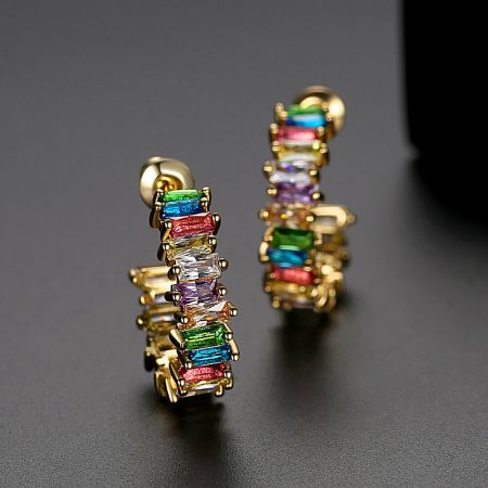 Side view of the gold rainbow gemstone hoop earrings showcasing the colorful stones.