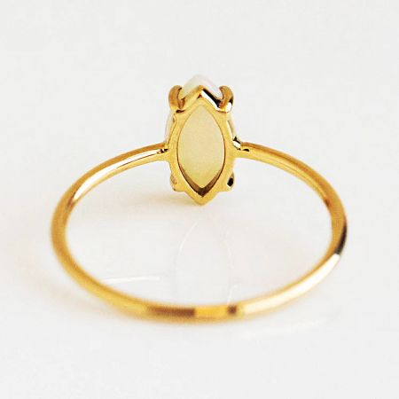 The elegant gold marquise setting of one of the stackable rings, showcasing the fine craftsmanship.