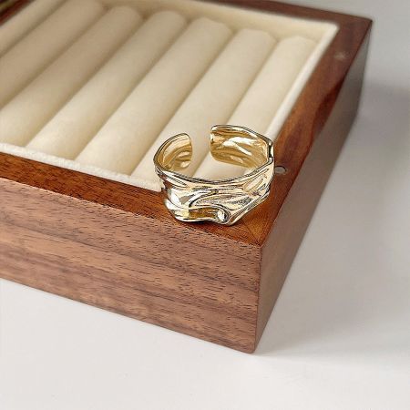 Detailed close-up of the gold geometrical polish ring, highlighting its hammered texture.