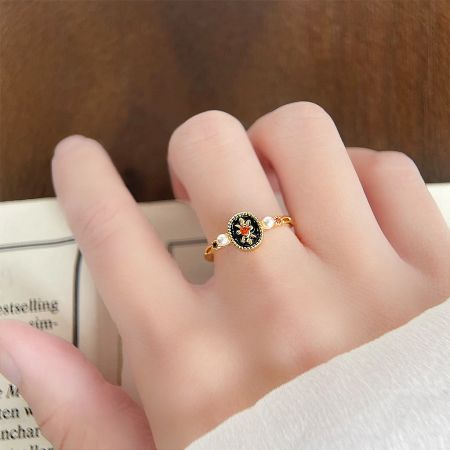 Retro 14k Gold Plated Black Enamel with Pearl and Zircon Open Finger Rings Set of 5 - A detailed view of a retro 14k gold plated ring from the five-piece set, featuring a black enamel flower design and delicate pearl accents.