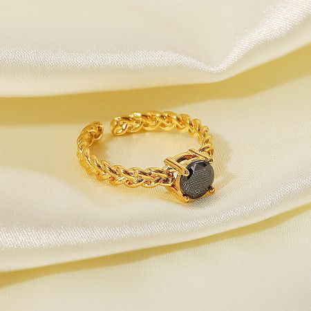 Close-up of the adjustable open ring with a striking black cubic zirconia stone.
