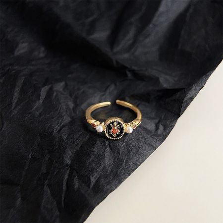Another design from the vintage ring set, showcasing a black and red centerpiece with pearls.