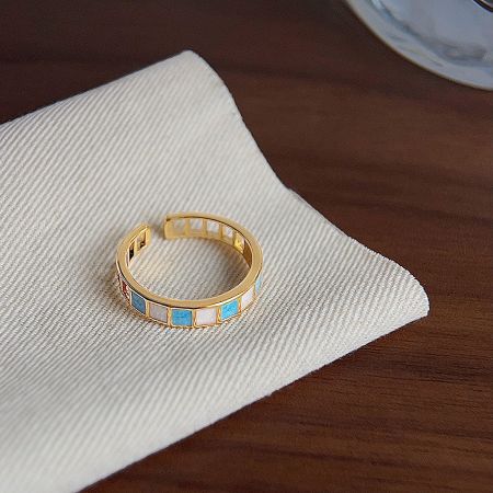 A gold-plated ring with striking blue and white stone details, part of the five-piece set.