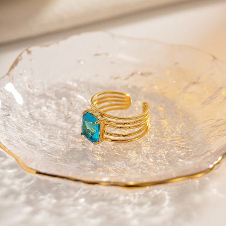 Detailed view of the multi-strand design of the gold-plated stainless steel ring.