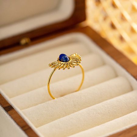 Detailed view of the gold-plated stainless steel ring with a lapis lazuli stone.