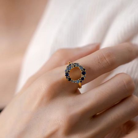 Elegant gold-plated sterling silver ring with a vibrant blue CZ stone.