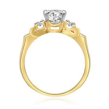 Angled view of the two-tone three-stone engagement ring, highlighting the brilliance of the princess-cut cubic zirconia against the polished brass band.