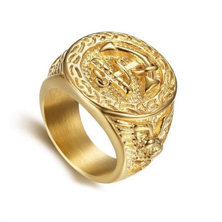 Gold Plated Stainless Steel Ring For Men - A detailed close-up of the Gold Plated Stainless Steel Ring for Men (Men-035), showcasing its intricate crest emblem and ornate band engravings.